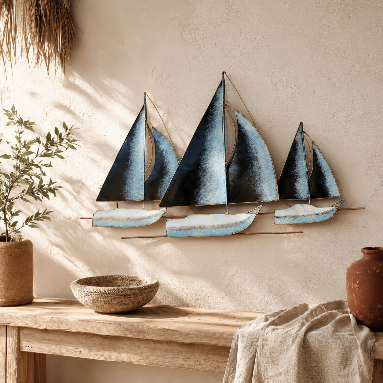 Decorative wall art of sailboats on a neutral wall with a wooden shelf and plants.